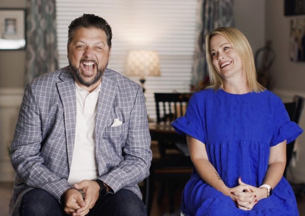 A man and woman sitting next to each other.